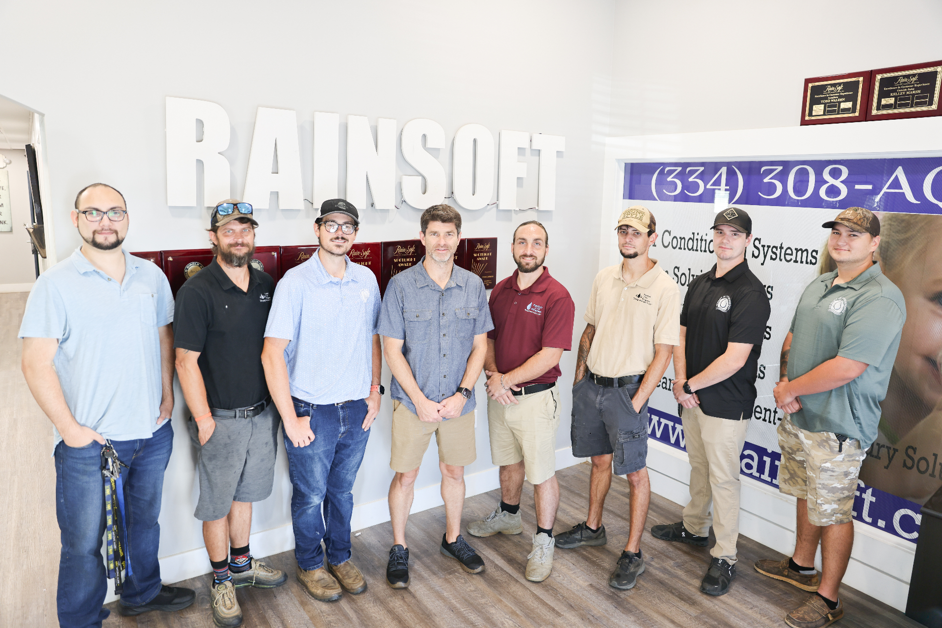 RainSoft of the Wiregrass team posing in office with awards