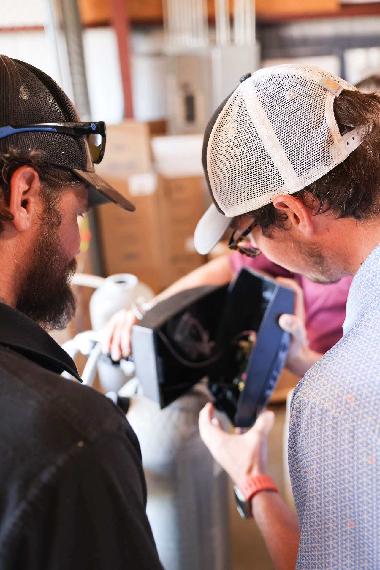 Team members inspecting water system components up close