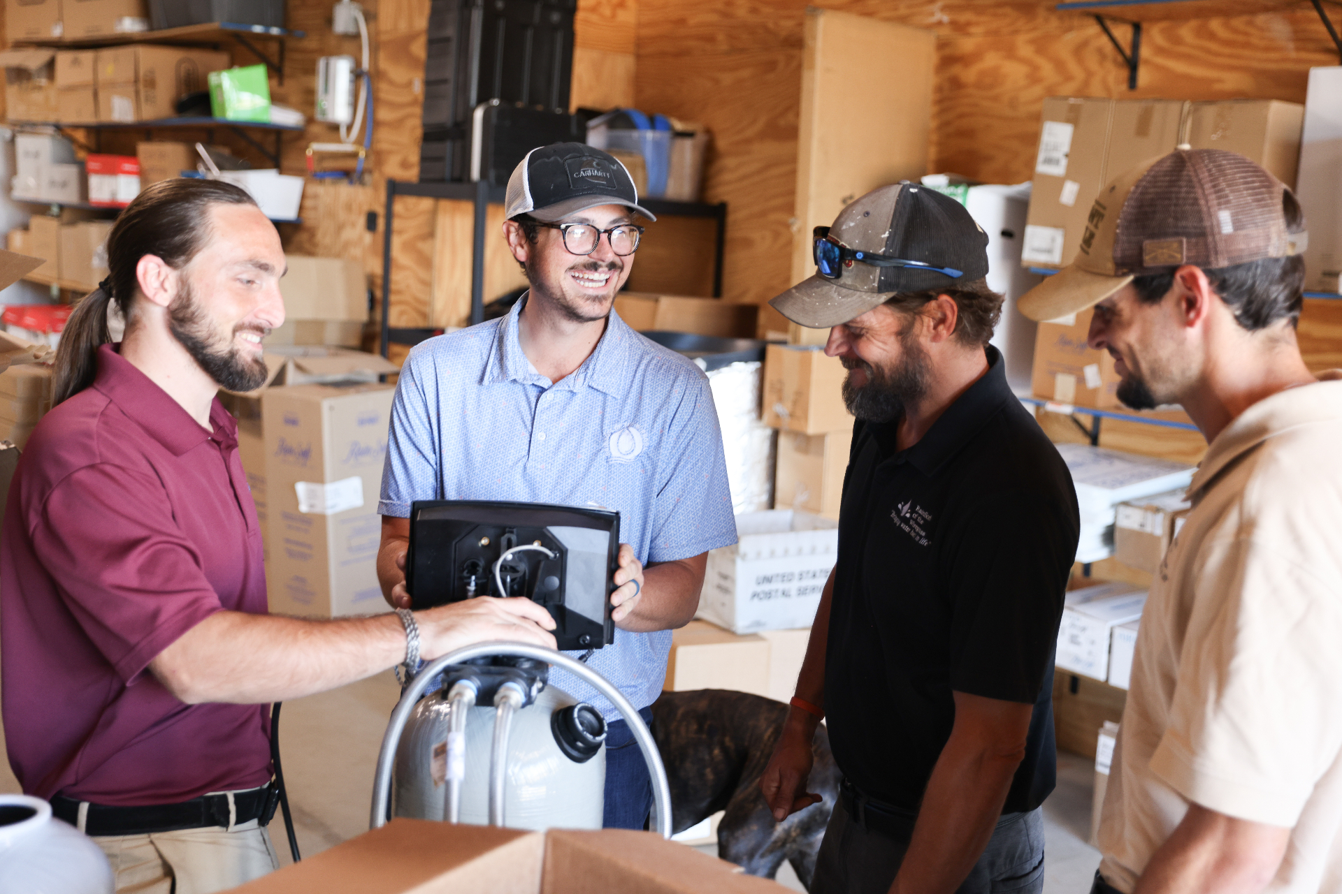 RainSoft crew collaborating on equipment setup in warehouse