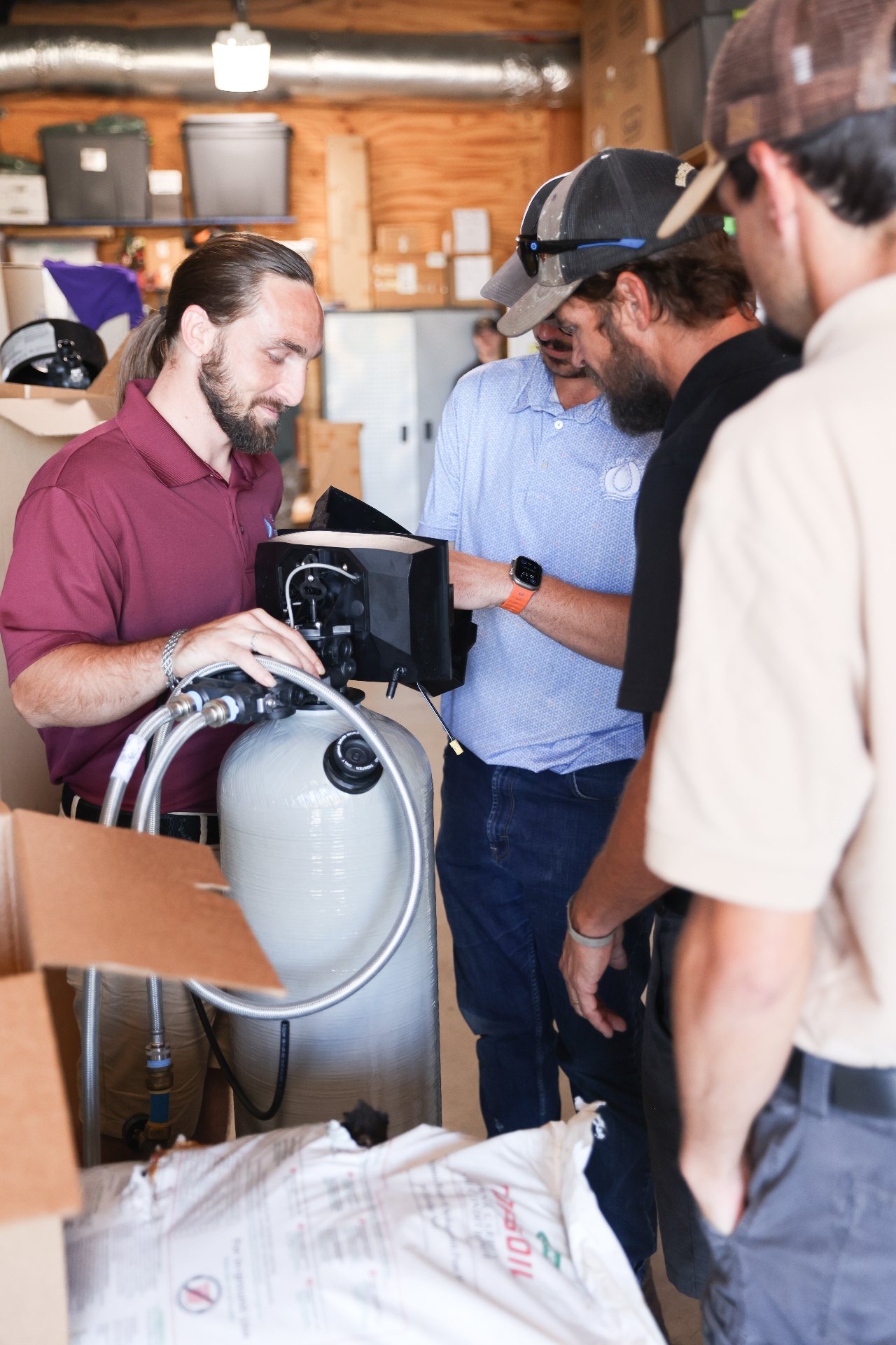 RainSoft technicians training on water treatment equipment in warehouse